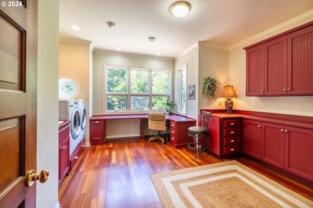 office featuring light hardwood / wood-style floors, built in desk, separate washer and dryer, and ornamental molding