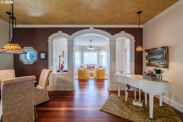 dining room featuring ornate columns, ornamental molding, dark wood-type flooring, and an inviting chandelier