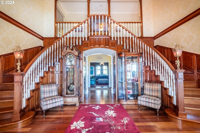 interior space with hardwood / wood-style flooring and a towering ceiling