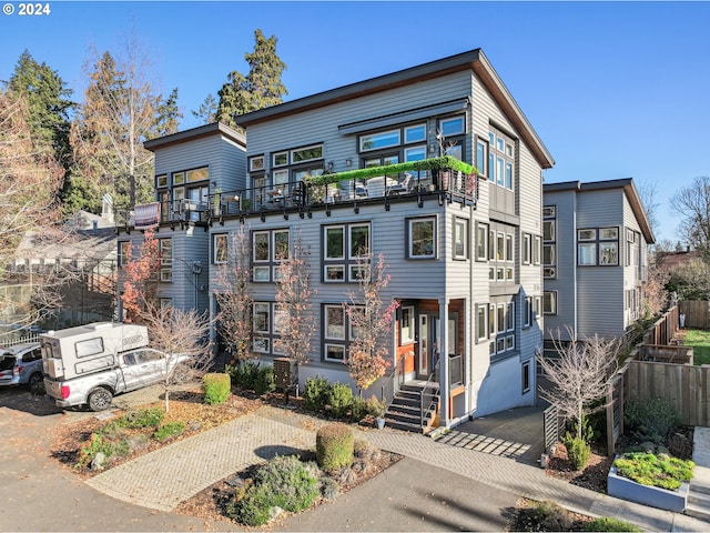 view of front of property featuring a balcony