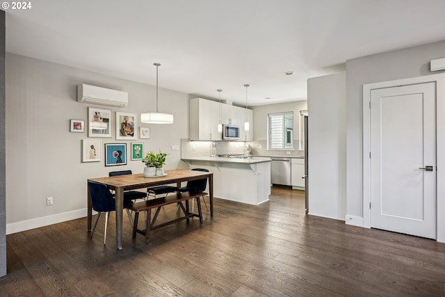 7926 SE 6th Ave Unit 4, Portland, OR 97202 - dining space with a wall unit AC, dark wood-style floors, and baseboards
