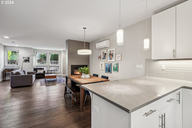 7926 SE 6th Ave Unit 4, Portland, OR 97202 - kitchen with a wall unit AC, a peninsula, recessed lighting, dark wood-type flooring, and backsplash