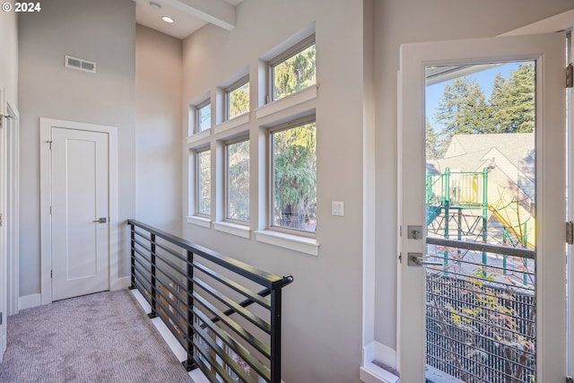 7926 SE 6th Ave Unit 4, Portland, OR 97202 - corridor featuring plenty of natural light, baseboards, an upstairs landing, a high ceiling, and carpet floors
