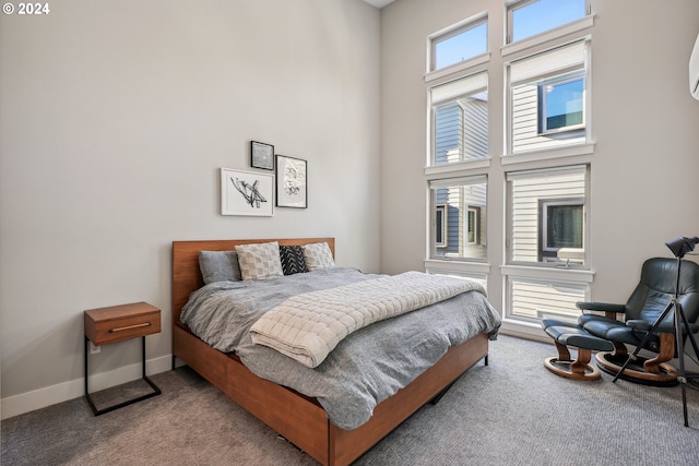 bedroom featuring a towering ceiling and carpet floors