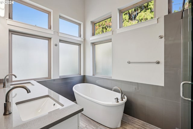 7926 SE 6th Ave Unit 4, Portland, OR 97202 - full bathroom with tile walls, a freestanding tub, a shower stall, double vanity, and a towering ceiling