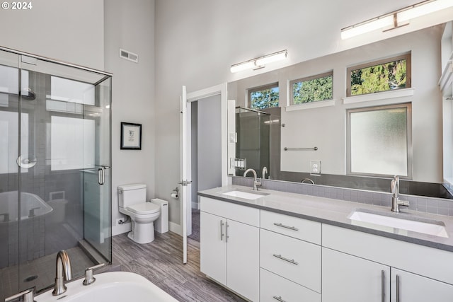 7926 SE 6th Ave Unit 4, Portland, OR 97202 - full bathroom with double vanity, a stall shower, toilet, wood finished floors, and a high ceiling