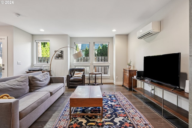 living room featuring dark hardwood / wood-style flooring and a wall unit AC