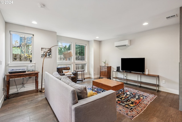 living room featuring dark hardwood / wood-style floors and a wall mounted AC