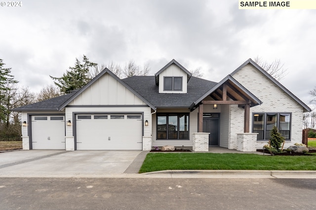 view of front of home with a front lawn and a garage