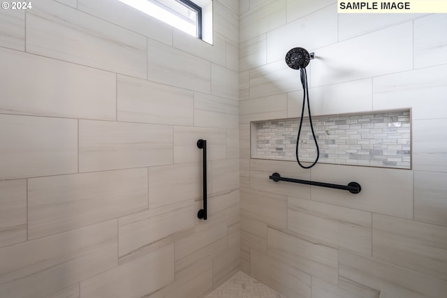 bathroom with a tile shower