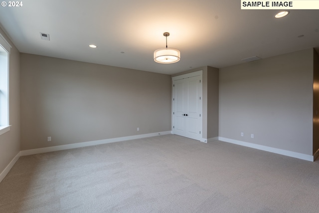 empty room featuring light carpet