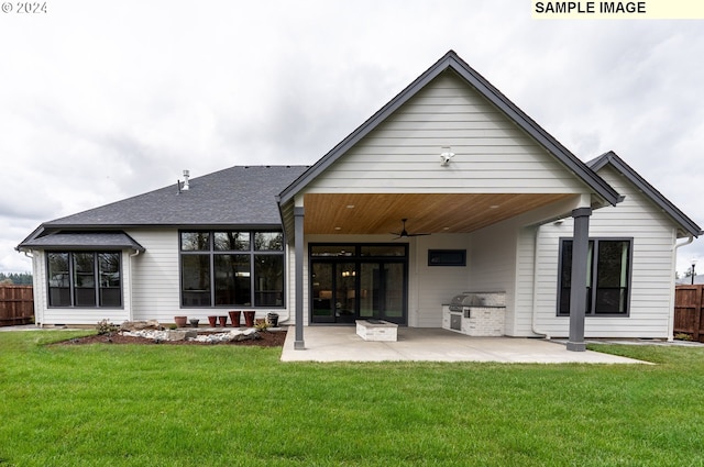 back of property with a yard, ceiling fan, and a patio area