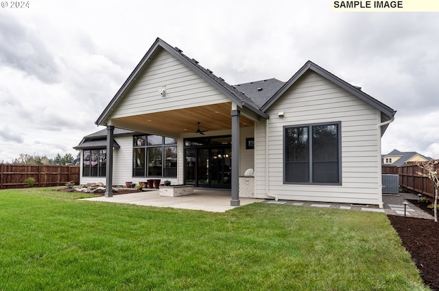 rear view of property with a yard, a patio, and ceiling fan