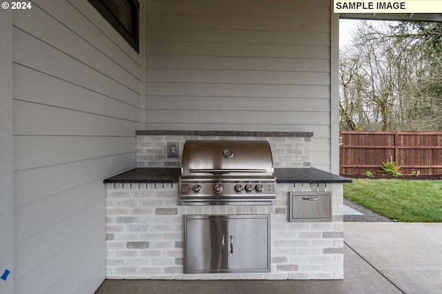 view of patio with an outdoor kitchen and area for grilling