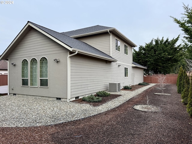 view of side of property with cooling unit