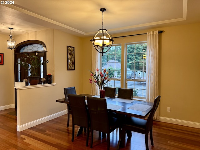 dining space featuring hardwood / wood-style flooring and a notable chandelier