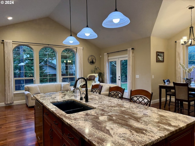 kitchen with pendant lighting, dark hardwood / wood-style flooring, lofted ceiling, and sink