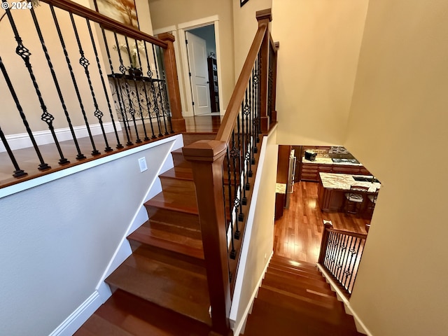 stairway featuring hardwood / wood-style floors