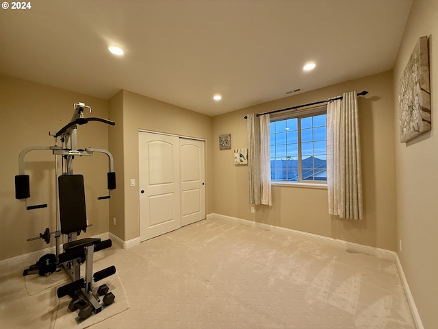 workout room with light colored carpet