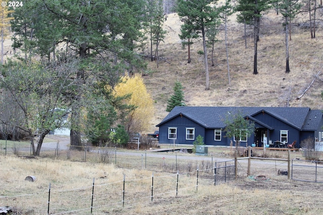 view of yard with central AC and a rural view