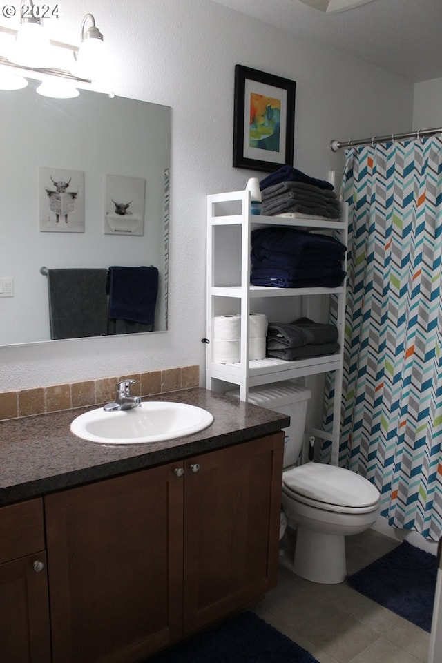 bathroom with vanity, a shower with shower curtain, and toilet