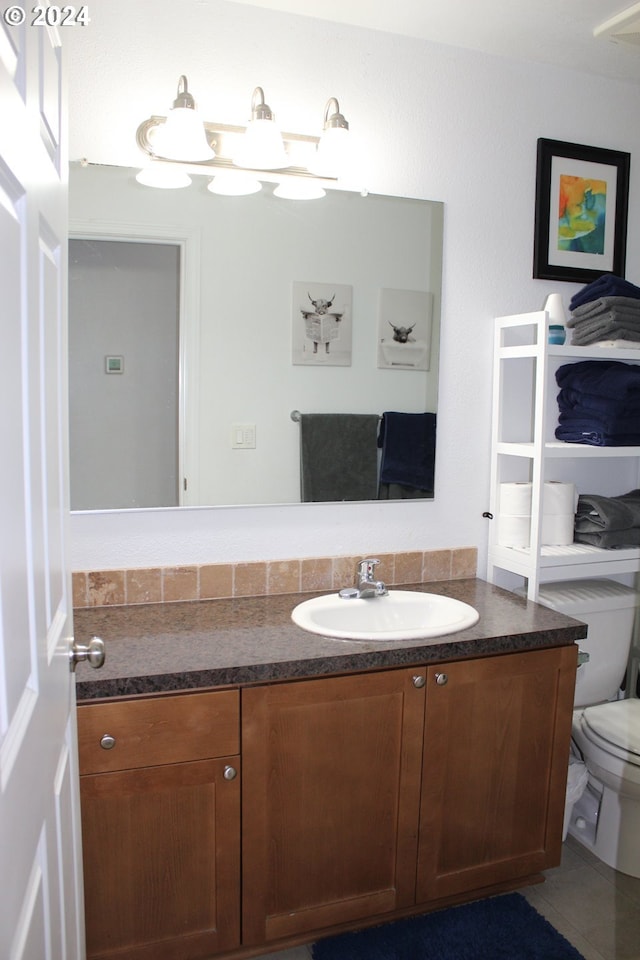 bathroom with toilet and vanity