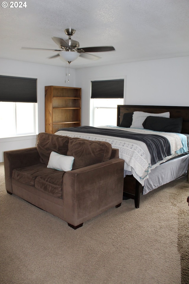 bedroom featuring multiple windows, carpet, and ceiling fan