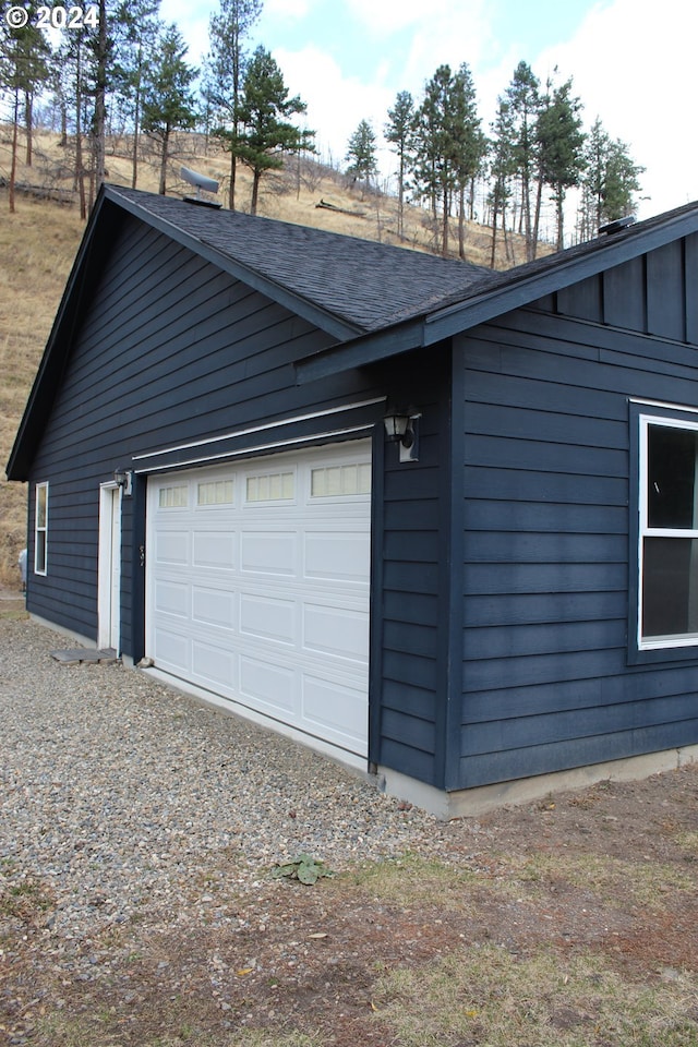 view of home's exterior featuring a garage and an outbuilding