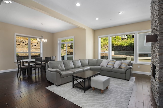 living room featuring dark hardwood / wood-style flooring and an inviting chandelier