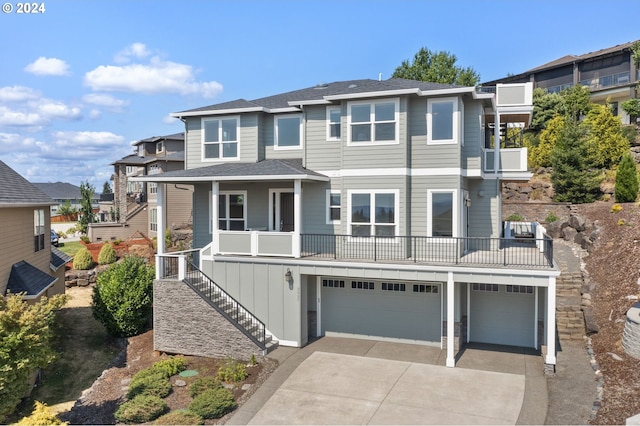 view of front of property featuring a balcony and a garage