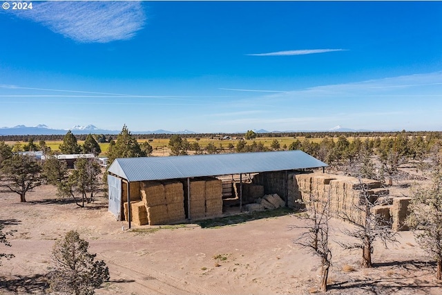 view of outbuilding featuring a mountain view and an outdoor structure