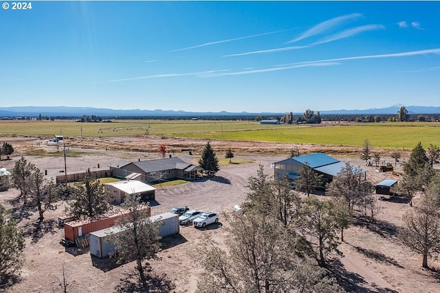 birds eye view of property featuring a mountain view and a rural view