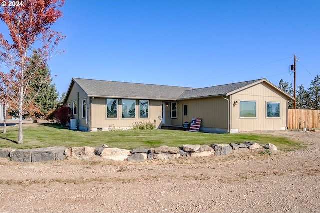 ranch-style house with crawl space, a shingled roof, a front lawn, and fence