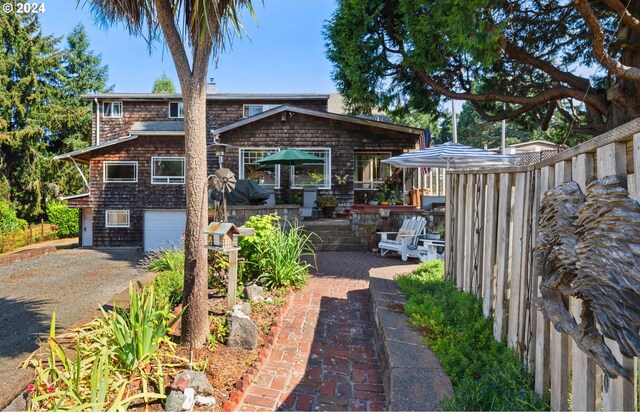 rear view of property with a garage