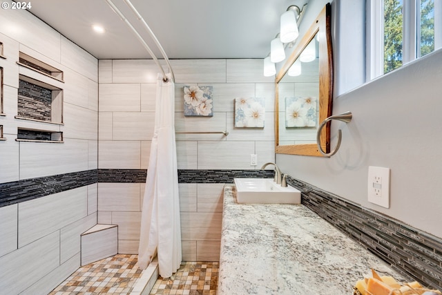 bathroom featuring vanity, a shower with curtain, and tile walls