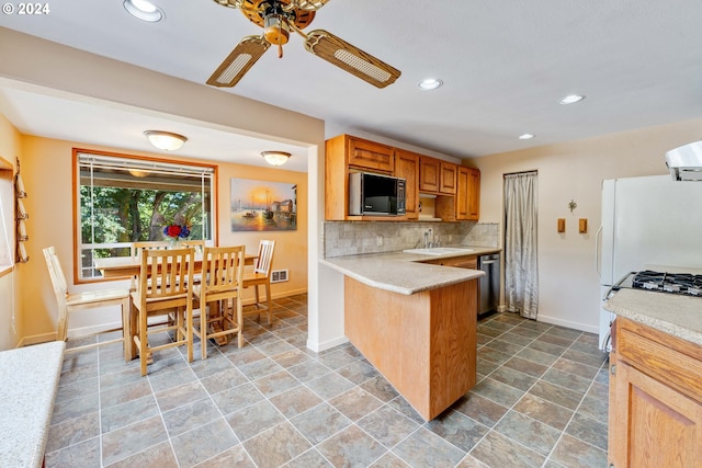 kitchen with black microwave, tasteful backsplash, tile patterned floors, kitchen peninsula, and ceiling fan