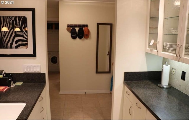 bathroom with sink, tile patterned flooring, and washer / dryer