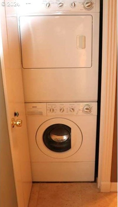 laundry room with stacked washer and clothes dryer