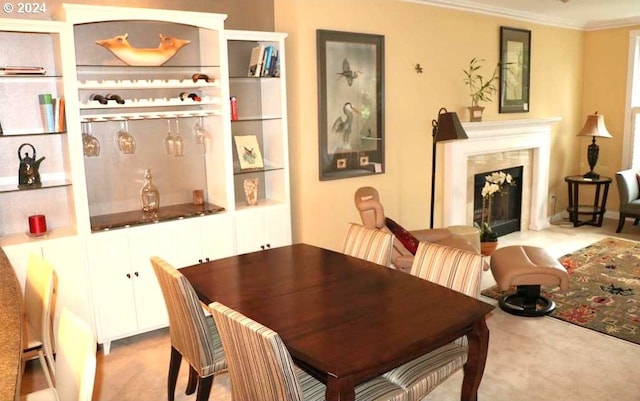 carpeted dining area with crown molding