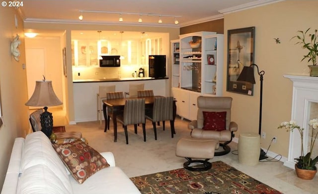 living room with light carpet, rail lighting, and ornamental molding