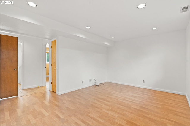 unfurnished room featuring light wood-style floors, recessed lighting, visible vents, and baseboards