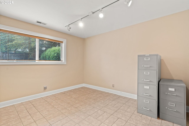 empty room featuring baseboards and visible vents