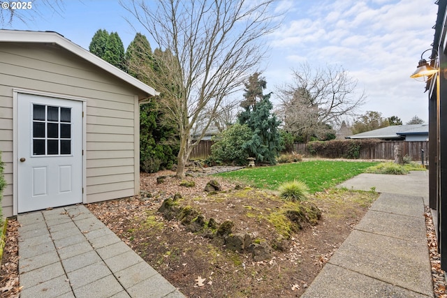 view of yard featuring an outbuilding and a fenced backyard