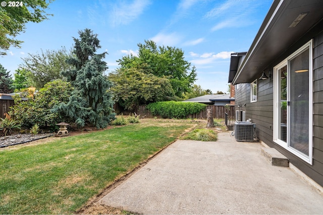 view of yard featuring central AC, a patio, and a fenced backyard