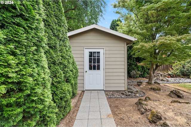 view of shed featuring fence