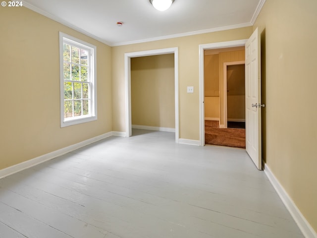 unfurnished bedroom with light hardwood / wood-style flooring and ornamental molding