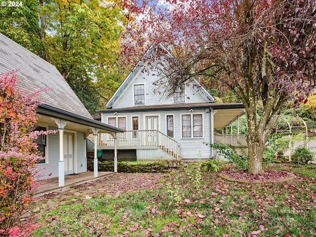 back of property with a porch