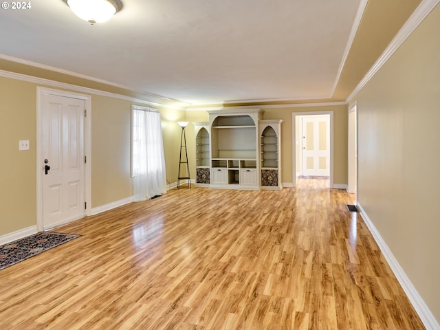 unfurnished living room featuring light hardwood / wood-style flooring and crown molding