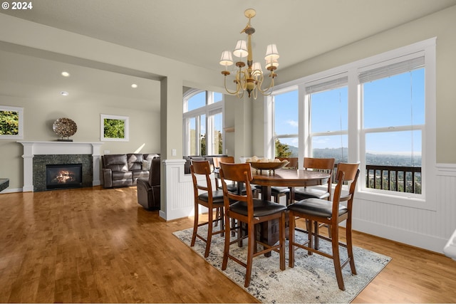 dining space with a notable chandelier and light hardwood / wood-style flooring