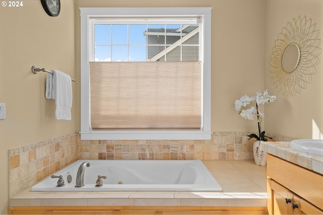 bathroom with vanity and tiled bath